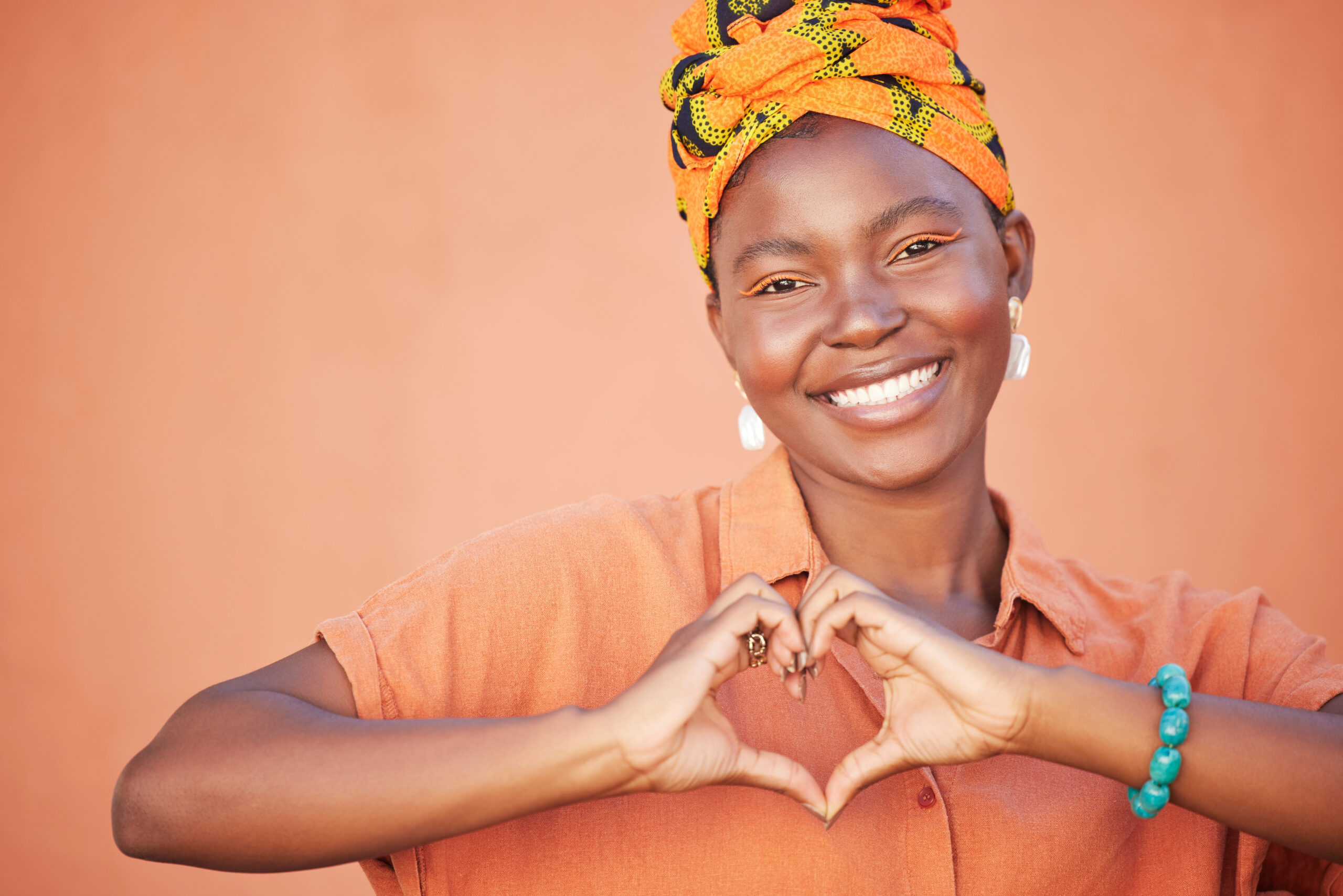 Portrait of black woman, heart hands and emoji for love, care and kindness, trust and support on or.